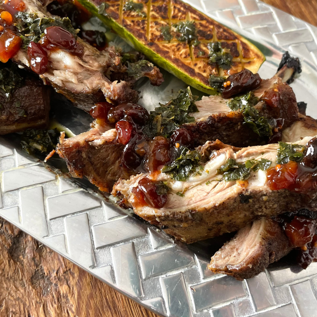 Second image of carved roasted lamb breast with herb oil & Cherry Jalapeno Chutney 